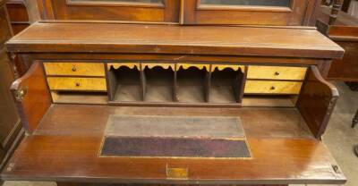 A late Victorian walnut cabinet secretaire bookcase, with moulded cornice, two moulded and glazed panelled doors, revealing adjustable shelves, over a fielded secretaire drawer with brass back plate loop handles and a fitted interior with pigeon holes and - 2