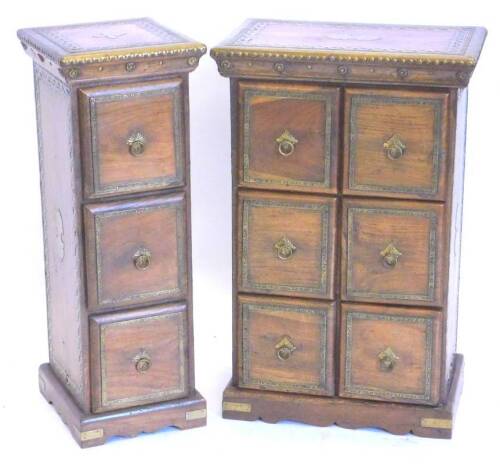 Two similar Eastern hardwood three drawer chests, each applied with pierced and hammered brass on bracket feet, the largest 42cm W.