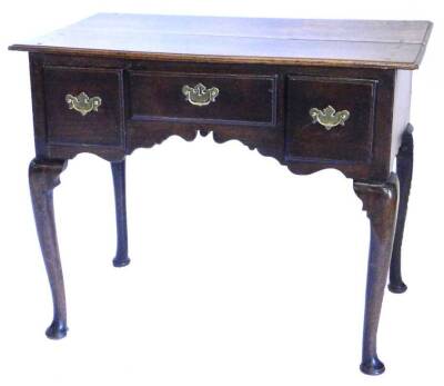 A late 18th/ early 19thC oak lowboy, the rectangular top with a moulded edge above three drawers, with a shaped apron on cabriole legs, on pad feet, 91cm W. Provenance: The property of Joan Stephenson, Kirkwood, North Church Walk, Newark, Nottinghamshire.