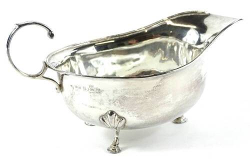 A George V silver sauce boat, of cape form, with 'c' scroll handle, on triple hoof supports, Birmingham 1912, 9cm H, 3oz. Provenance: The property of Joan Stephenson, Kirkwood, North Church Walk, Newark, Nottinghamshire.