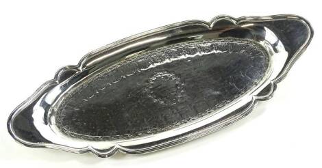 A George III silver pen tray, of shaped oval form, chased to the centre with a repeat banding and garlands, London 1815, 24cm W, 4½oz. Provenance: The property of Joan Stephenson, Kirkwood, North Church Walk, Newark, Nottinghamshire.