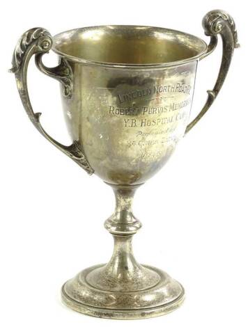 A George V silver trophy by Walker and Hall, of campana form, with an acanthus capped scroll handles on an inverted stem and circular foot, partially engraved Lincoln North Road F.C. Robert Pervis memoriam W.B. Hospital cup 1915, Sheffield 1911, 24cm H, 1