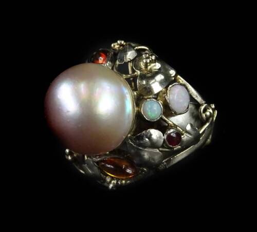 A pearl and gemstone set Arts & Crafts style ring, with foliate twist design, set with citrines, rubellite, and opal, with central cultured pearl, 12.78mm dia, with AnchorCert Gem lab report, ring size L½, in white metal setting, unmarked, 13.3g all in.