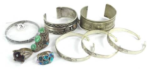 Various silver and silver plated jewellery, mainly of Eastern design, to include a set of three silver plated bangles, a silver plated Eastern style bangle, a silver and stone set bangle, three dress rings and a further bangle (a quantity).