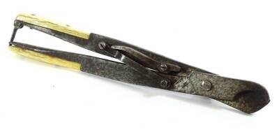 A pair of 19thC medical cutter or pliers, with bone handles and an articulated centre, 21cm W.