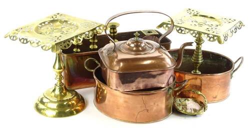 A quantity of Victorian and later copper and brass, to include a near pair of trivets, a square kettle, candlesticks, etc.