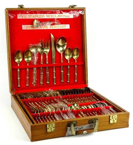 A canteen of nickel bronze cutlery, bamboo style handles to include serving pieces, settings for twelve, in fitted teak canteen, 3cm W.