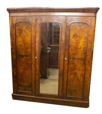 A Victorian figured walnut triple wardrobe compactum, with moulded cornice, central mirror door, with panel door to the left (when opened) revealing press drawers and solid drawers with campaign handles, and full length hanging to the right hand door, on