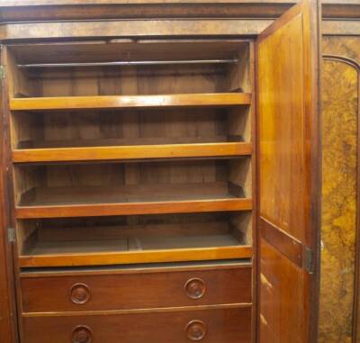 A Victorian burr and figured walnut triple wardrobe, with moulded cornice, arch moulded mirror centre door, revealing a double width arrangement of press drawers and solid drawers with integral moulded handles to the left and full length hanging with box - 2