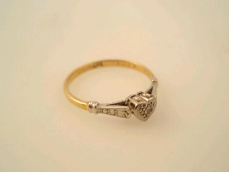 A small heart shaped tiny diamond set ring