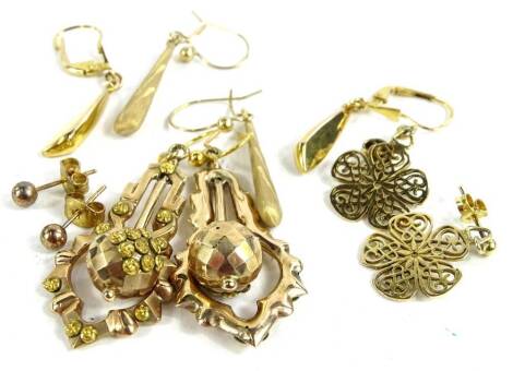 Five pairs of 9ct gold earrings, to include a pair of Eastern style drop earrings, frosted design tear shaped drop earrings, modern drop earrings, floral drop earrings and a pair of studs, all yellow metal, some marked 375, 8.3g all in.