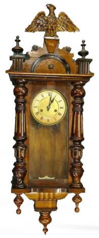 A late 19th/early 20thC walnut Vienna type wall clock, with a composite gilt eagle to the shaped crest, above part fluted and turned pilasters, embellished with dropped finial, 89cm H.