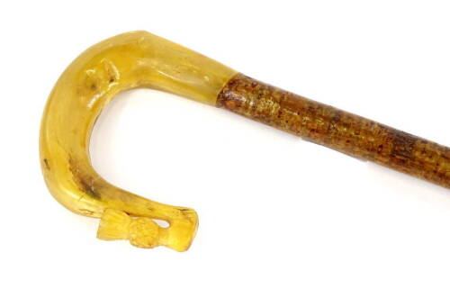 A shepherd's crook with a carved horn handle