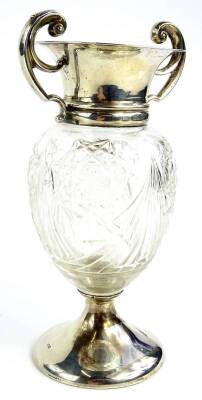 An Edwardian cut glass and silver mounted vase, with two scroll shaped handles and a domed foot, loaded, Birmingham 1907, 8¾oz gross, 17cm H.