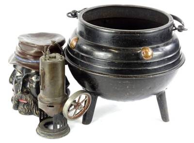 A late 19th/early 20thC Arts & Crafts style cast iron cauldron, with copper roundels, a tobacco jar and cover moulded and painted in a bronze colour with faces and part of a static engine (3) - 2