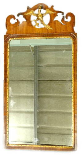 A George III mahogany fret frame wall mirror, the later rectangular plate with a gilt slip, the crest decorated with a ho-ho bird in gilt, adapted, 92cm x 46cm. Provenance: The property of Joan Stephenson, Kirkwood, North Church Walk, Newark, Nottinghamsh