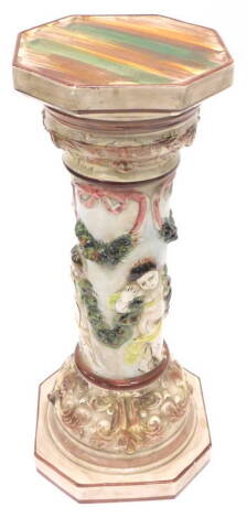 A Capodimonte pottery jardiniere stand, decorated with putti, swags of flowers etc., on a canted square base, printed mark in black to underside, 63cm H.