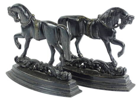 A pair of cast iron fire ornaments each modelled in the form of a horses. Provenance: The property of Joan Stephenson, Kirkwood, North Church Walk, Newark, Nottinghamshire.