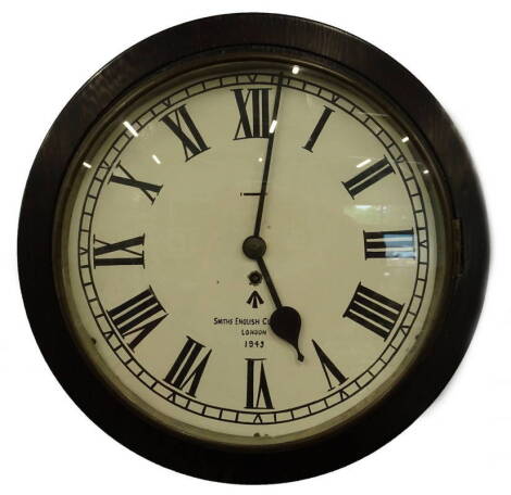 An ebonised wall clock, the painted dial bearing inscription Smiths English Works Limited, with military arrow and bearing date 1943, 44cm dia.