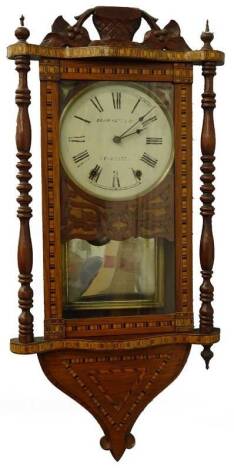 A late 19thC American walnut and parquetry wall clock, the painted dial stamped Skarratt and Co Worcester, with turned pillars, later carved crest etc., 82cm H.