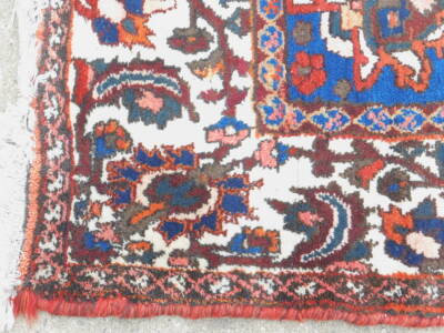 A Persian carpet, with an all over design of flowers, on a red ground with multiple borders, 314cm x 218cm. - 2