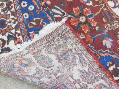 A Persian carpet, with an all over design of flowers, on a red ground with multiple borders, 314cm x 218cm. - 3