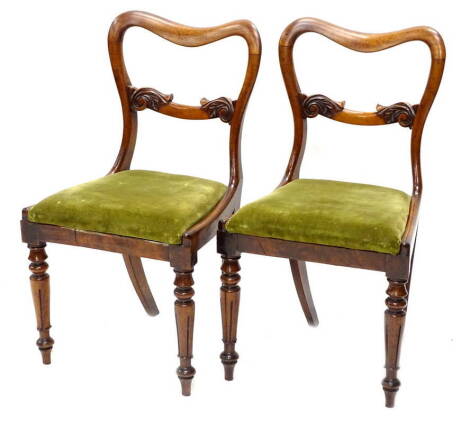 A pair of Victorian mahogany balloon back dining chairs, each with a drop in seat, on turned legs. Provenance: The property of Joan Stephenson, Kirkwood, Church Walk North, Newark, Nottinghamshire.