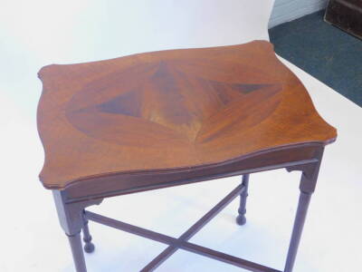 An early 20thC mahogany occasional table, the shaped top inlaid with various cuts of mahogany on turned tapering legs with X stretcher, 62cm W. - 2