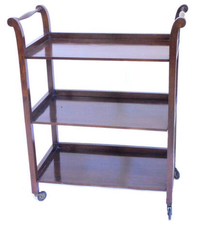 A mahogany three tier trolley, with turned handles and metal castors, 76cm W. Provenance: The property of Joan Stephenson, Kirkwood, North Church Walk, Newark, Nottinghamshire.