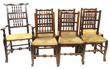 An associated set of six 19thC Lancashire type spindle back chairs, each with a rush seat and a similar armchair.