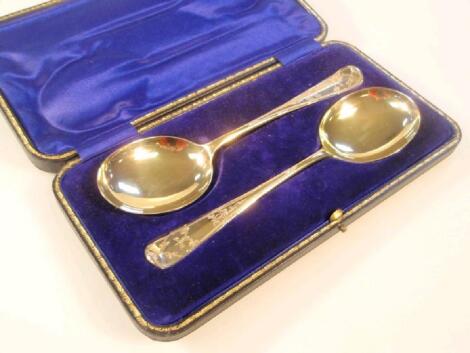 A pair of Edwardian silver gilt serving spoons