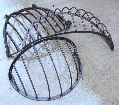 Three various early to mid 20thC bow fronted iron hay racks.