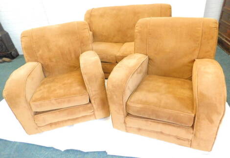 An Art Deco three piece suite, comprising two seater sofa and two armchairs, re upholstered in brown fabric. The upholstery in this lot does not comply with the 1988 (Fire & Fire Furnishing) Regulations, unless sold to a known exporter or upholsterer it w