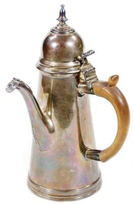 An Edwardian Britannia silver chocolate pot, by Goldsmith & Silversmith Company, Queen Anne style with domed thumb mould lid and urn finial, C scroll handle and tapering body, London 1905, 25cm H, 20oz all in.