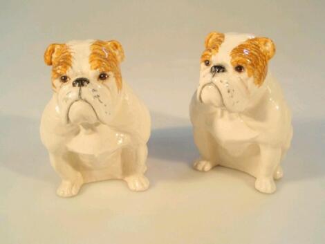 A pair of Royal Doulton models of seated bulldogs