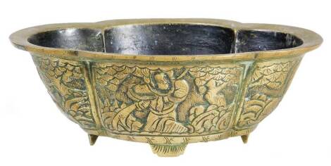 A Chinese polished bronze style dish, of shaped form, heavily raised with figures on four shaped feet, seal mark beneath, 22cm W.