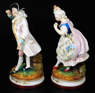 A pair of continental bisque porcelain figures, of a lady and gentleman, each dressed in finery, on naturalistic inverted circular bases with gilt highlights, polychrome decorated predominately in turquoise, pink and black, with further gilt highlights, L - 2