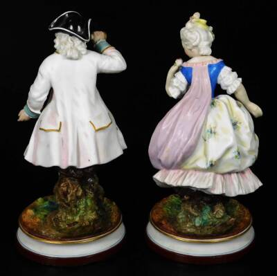 A pair of continental bisque porcelain figures, of a lady and gentleman, each dressed in finery, on naturalistic inverted circular bases with gilt highlights, polychrome decorated predominately in turquoise, pink and black, with further gilt highlights, L - 3