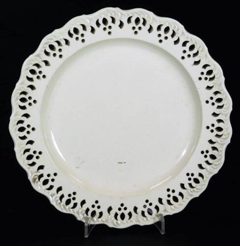 An early 19thC Wedgwood creamware plate, of flared form, with pierced and moulded border, impressed marks beneath, 19cm W.