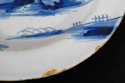 An 18thC Dutch Delft blue and white plate, of circular form, decorated with a scene of figure before buildings and boats, on a circular foot, no.2 beneath, 22cm Dia. and a further Japanese porcelain dish of octagonal form. (2) - 5