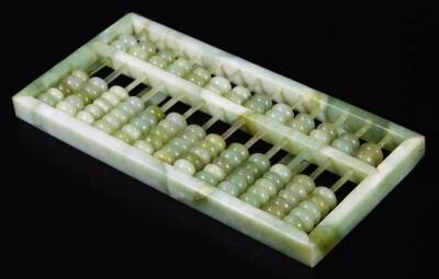 A polished green jade coloured abacus, of rectangular form, set with compressed beads, 25cm W. (boxed) - 2