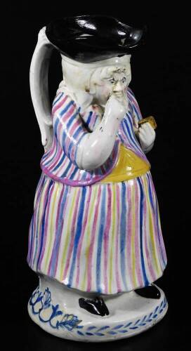 A 19thC female snuff taker pottery Toby jug, c.1830, 26cm H.