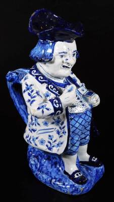 A Dutch Delft model of a snuff taking Toby jug, decorated in blue and white. 28cm H.