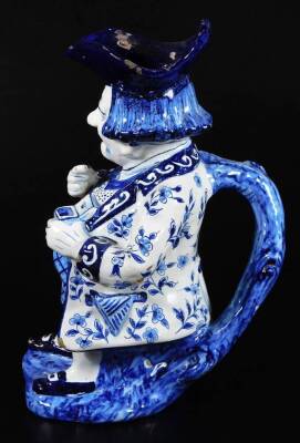 A Dutch Delft model of a snuff taking Toby jug, decorated in blue and white. 28cm H. - 3