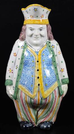 A French faience Toby jug decorated in bright colours, c.1900. 28cm H.