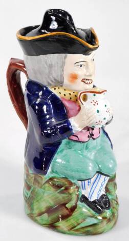 A late 19thC pottery coloured Toby jug and cover, possibly William Kent, polychrome decorated in blue, turquoise and green, 23cm H.