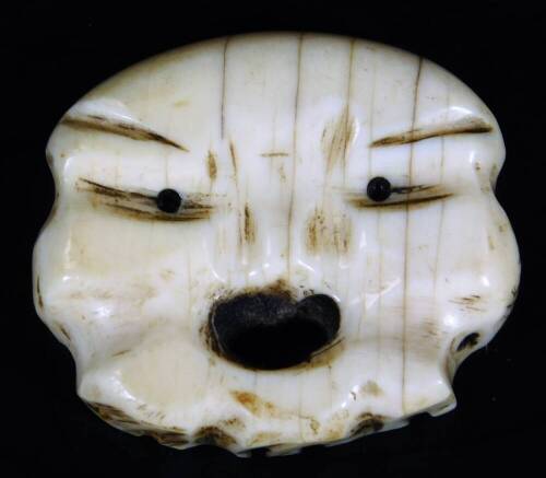 An early 20thC ivory netsuke modelled as a open mouthed face, 19thC, 5cm W.