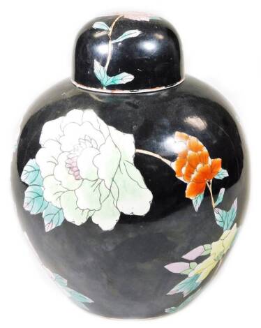 A 20thC Chinese ginger jar, of large proportion, the domed lid raised above a bulbous body polychrome decorated with flowers, predominately in green, orange and pink, on a black ground, unmarked, 38cm H.