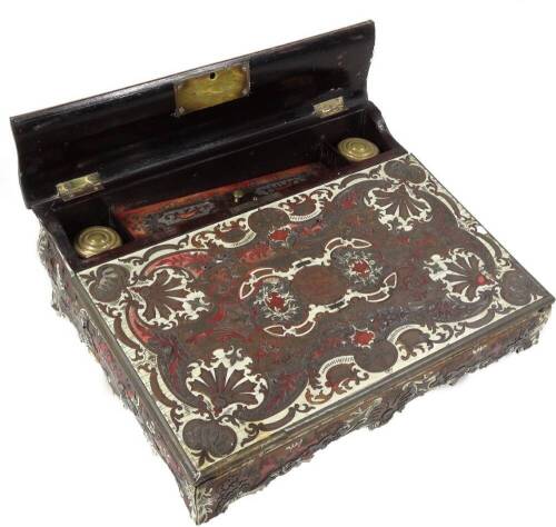 A 19thC Persian rosewood writing box, the serpentine hinged top revealing space for ink bottle and pens, the fall front with deep well, heavily set with scrolls and flowers, 11cm H, 32cm W, 24cm D. (AF)