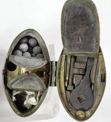 A 19thC brass and walnut pocket pistol, 19cm W and an eastern brass combination shot and powder flask of oval form. (2) - 2